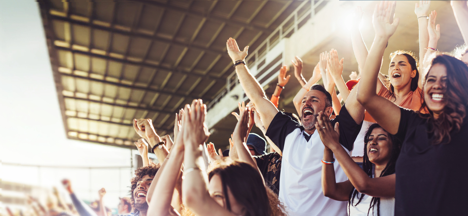 Football fans cheering in a packed stadium